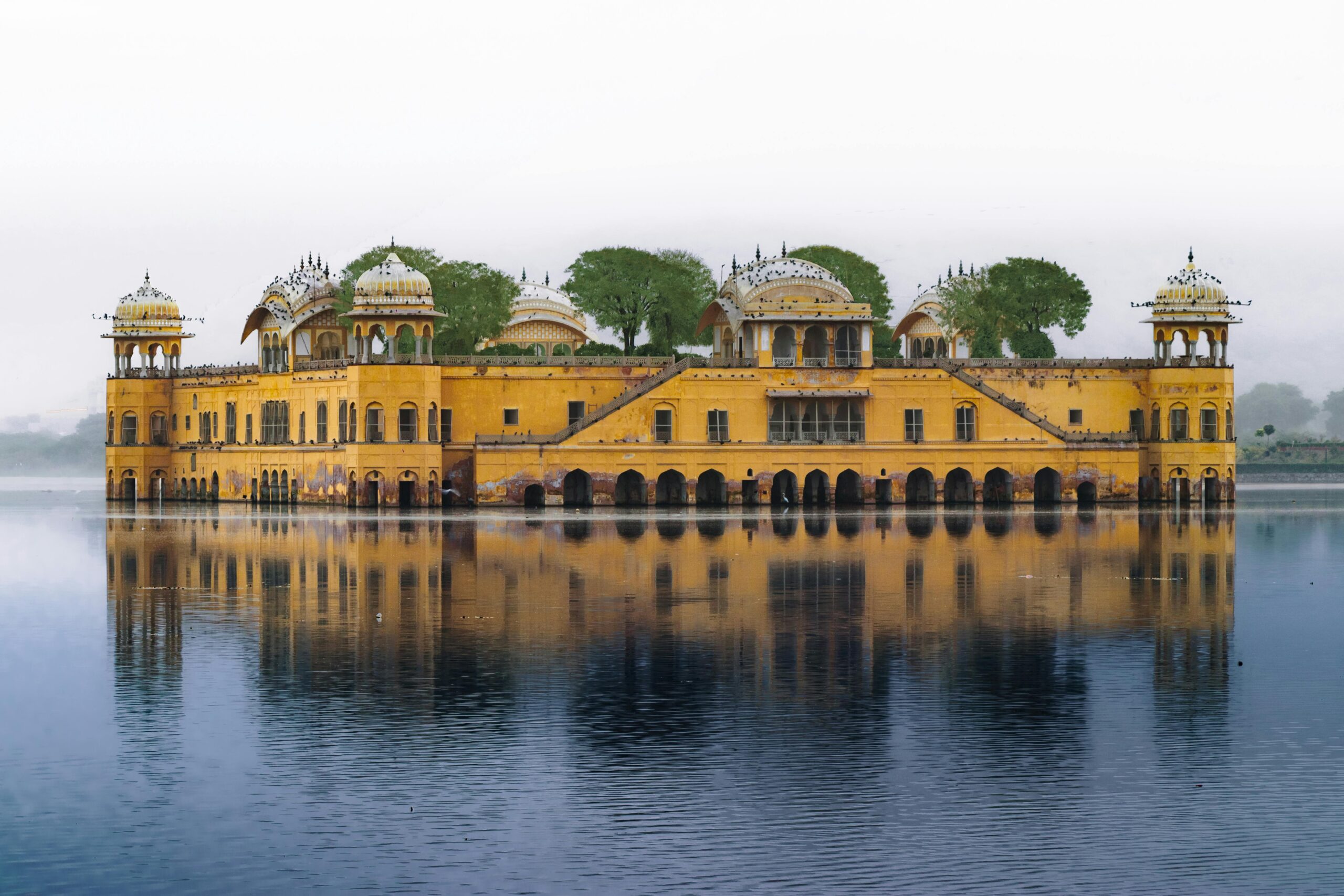 Stunning view of Jal Mahal palace reflecting on Man Sagar Lake in Jaipur, India.