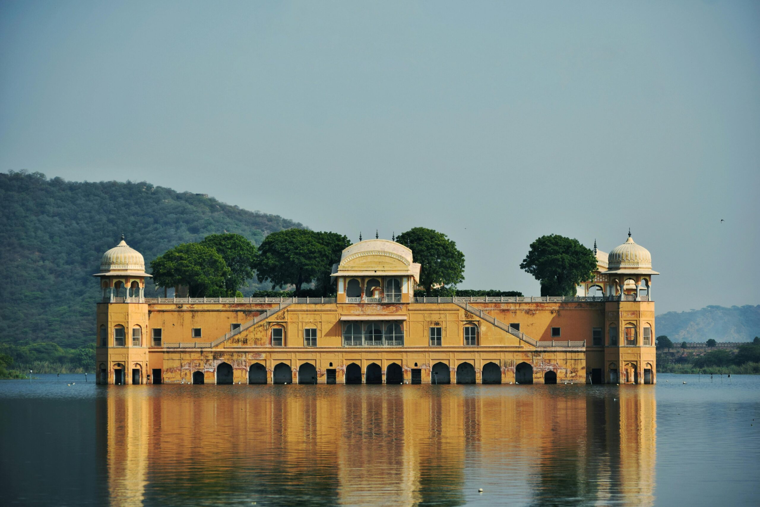 Beautiful view of Jal Mahal Palace in Rajasthan, India surrounded by water and nature.